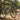 A dusty mountain bike leaning against a wooden fence post at the entrance of a forest trail in warm morning light.